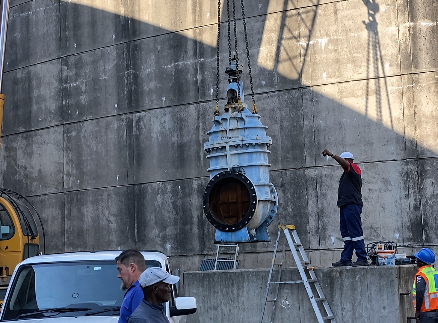 Large gate valve being craned into place on a Casnan Civils water reservoir installation